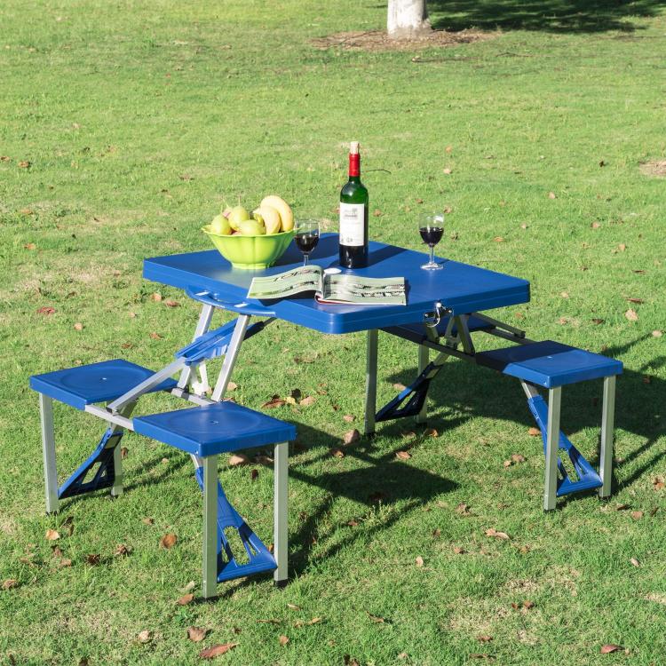 Blue colored Wooden Picnic Table Folds Into a Briefcase with picnic stuff on the grass