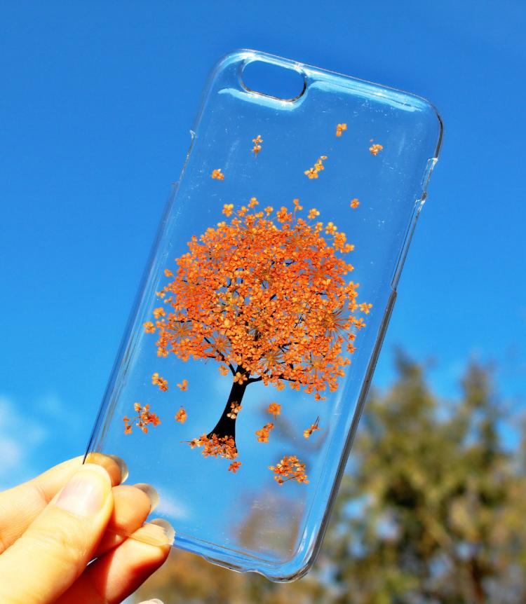 Orange colored flower tree pressed into a transparent phone case