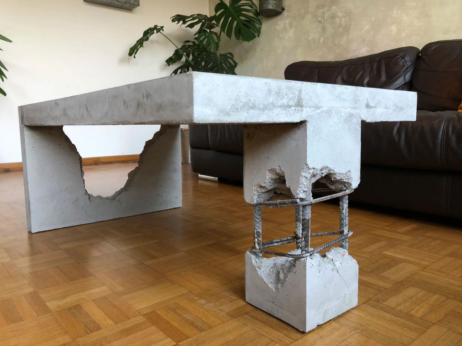 White ceramic concrete coffee table on a brown wooden floor
