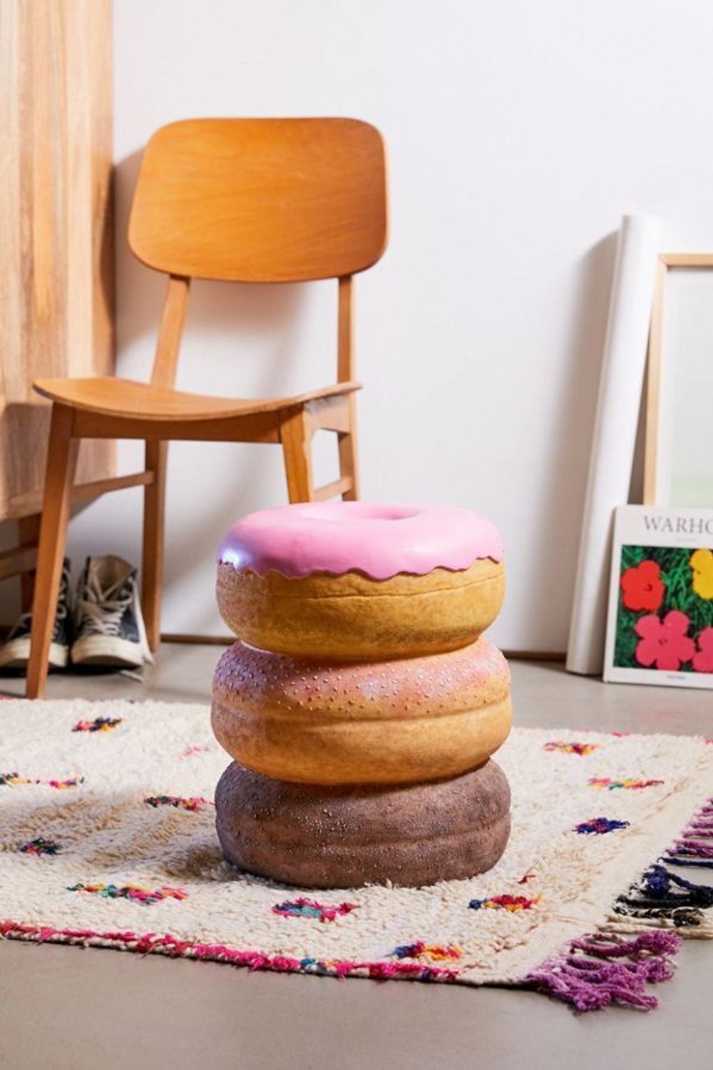 Stack of 3 donuts stool on a white and bit of multi colored rug