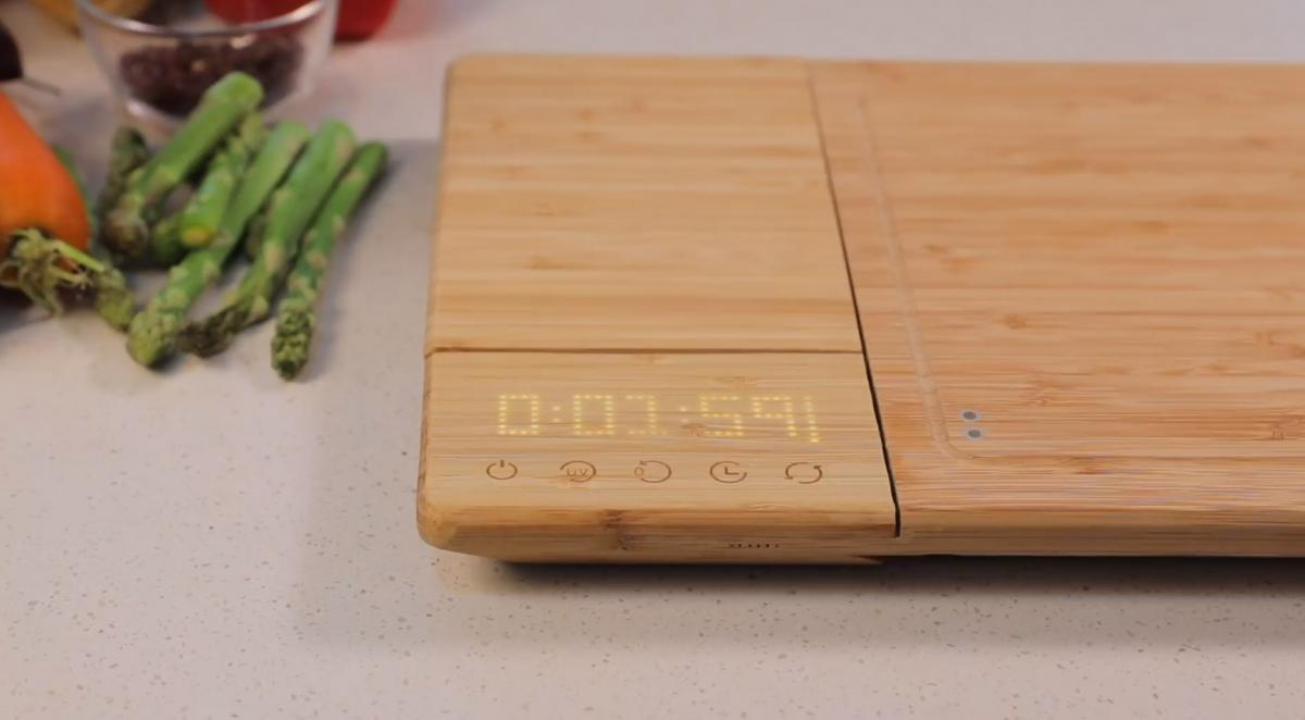 Smart Chop Smart Cutting Board with a digital timer on a white kitchenn top with some vegetables