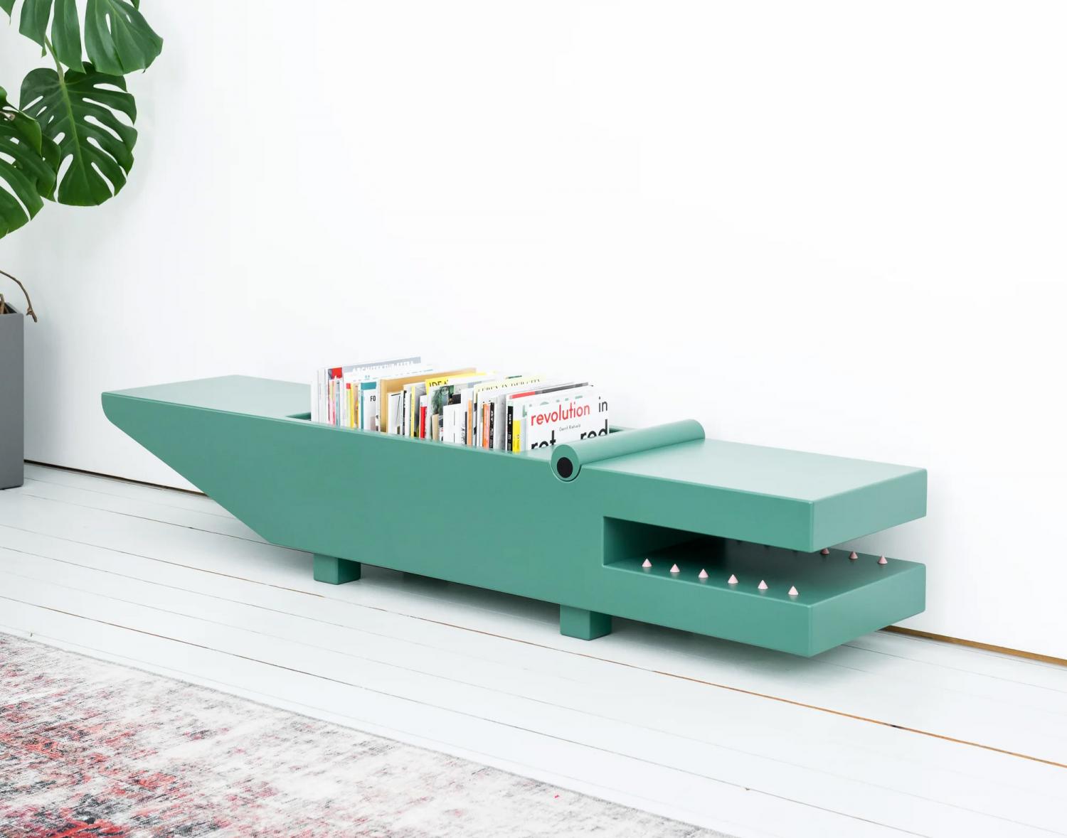 Green colored wooden Crocodile Storage Ottoman on a white wooden floor