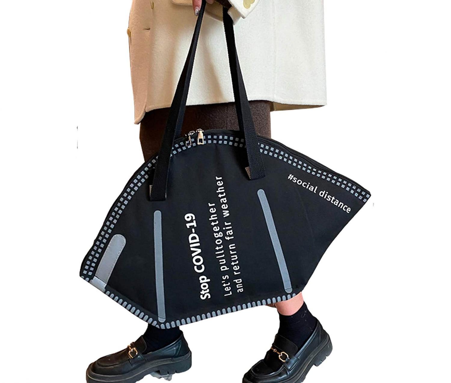 A girl wearing skin dress holding a black Giant Face Mask Tote Bag