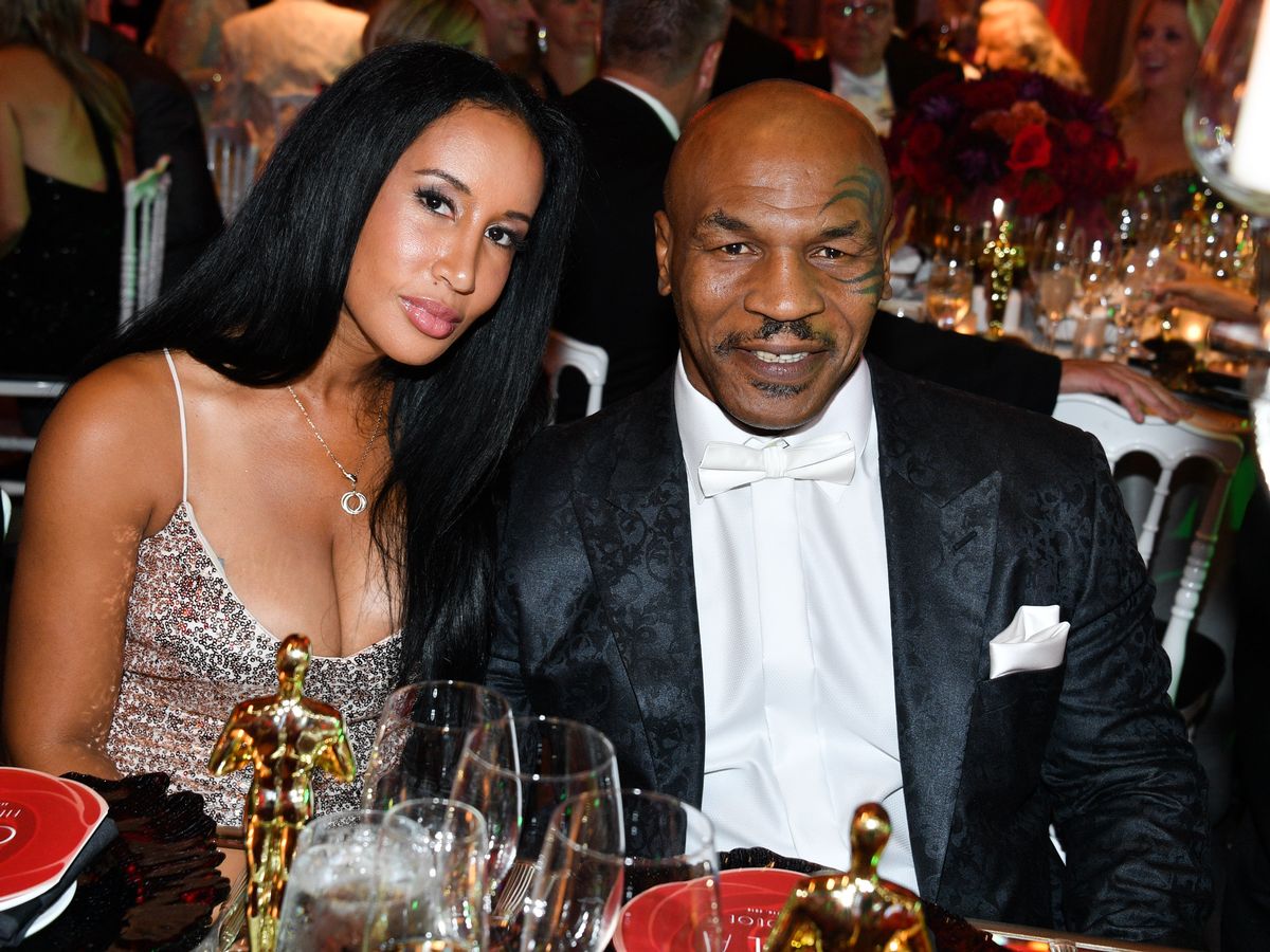 In a party, Mike Tyson And his wife, lakiha smiles at the camera