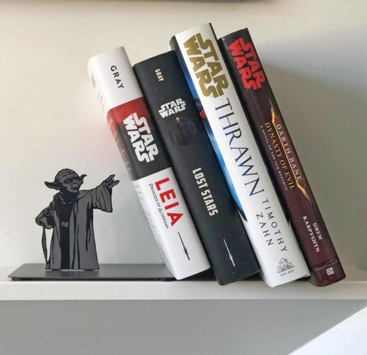 Black and grey colored Yoda holding four books