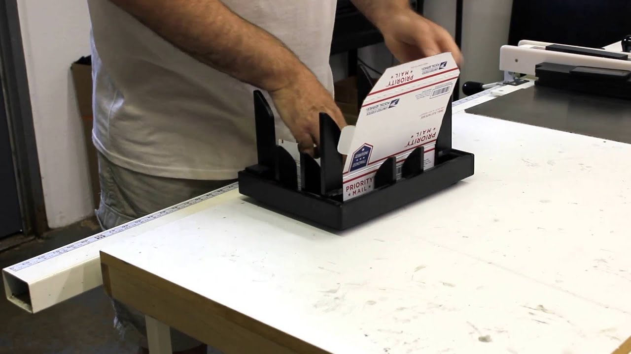 A man packing a priority mail box