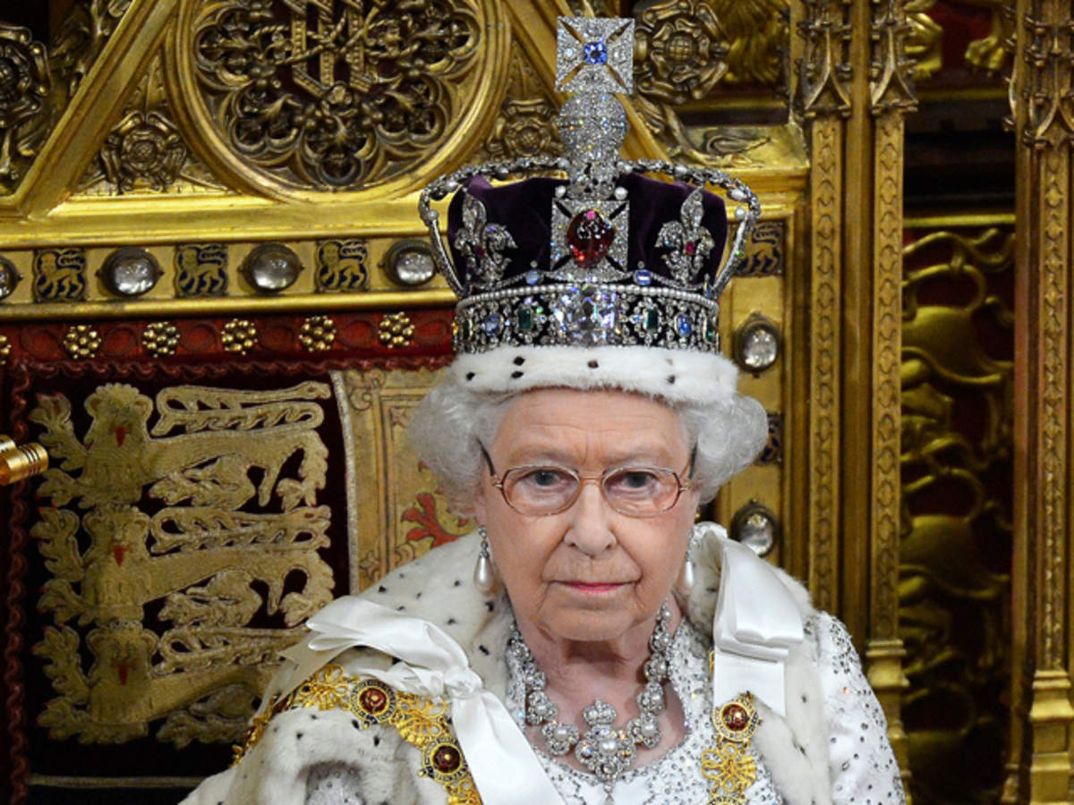 Queen Elizabeth sitting on her throne with the imperial state crown