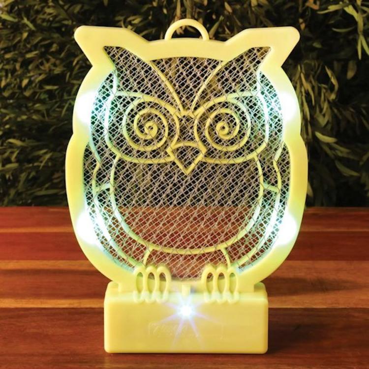Skin yellow-colored owl-shaped bug zapper on a wooden top