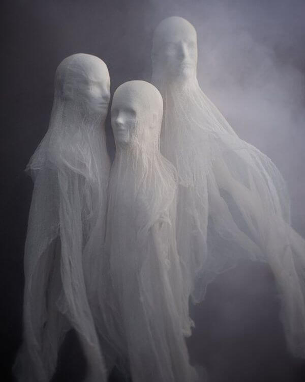 Three spooky white cheesecloth modules of spirits flowing freely