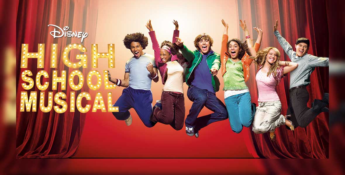 The main cast of the high school musical show jumping and smiling
