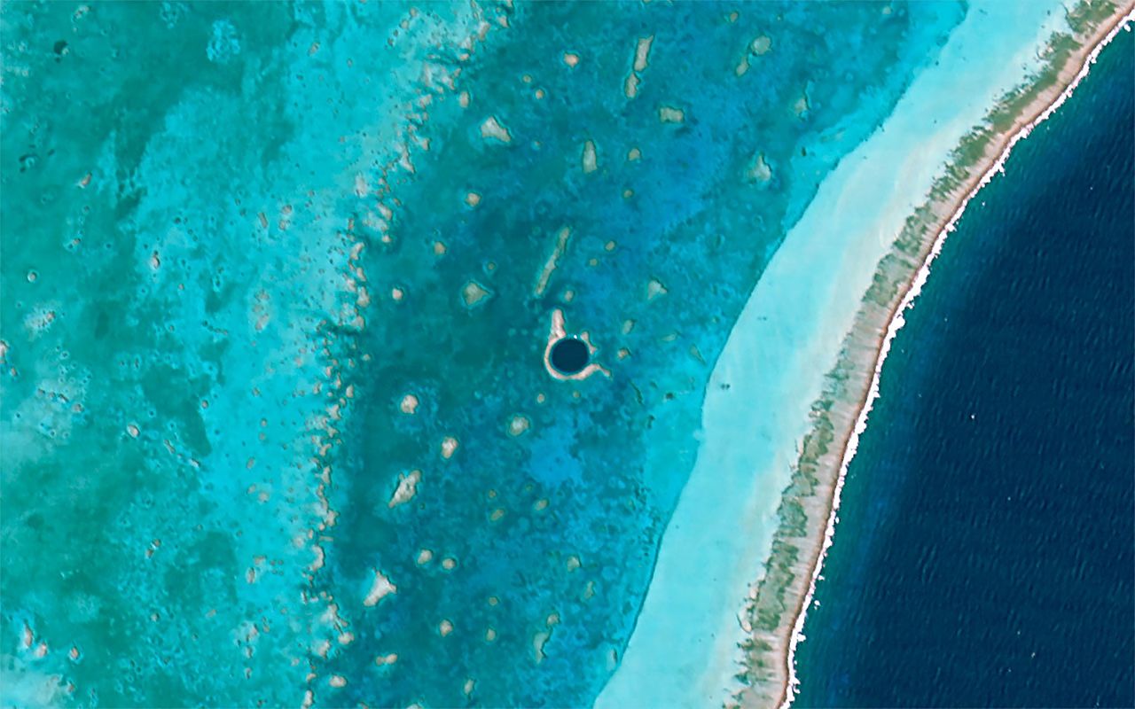 Aerial shot of blue and dark blue colored Great blue hole of Belize