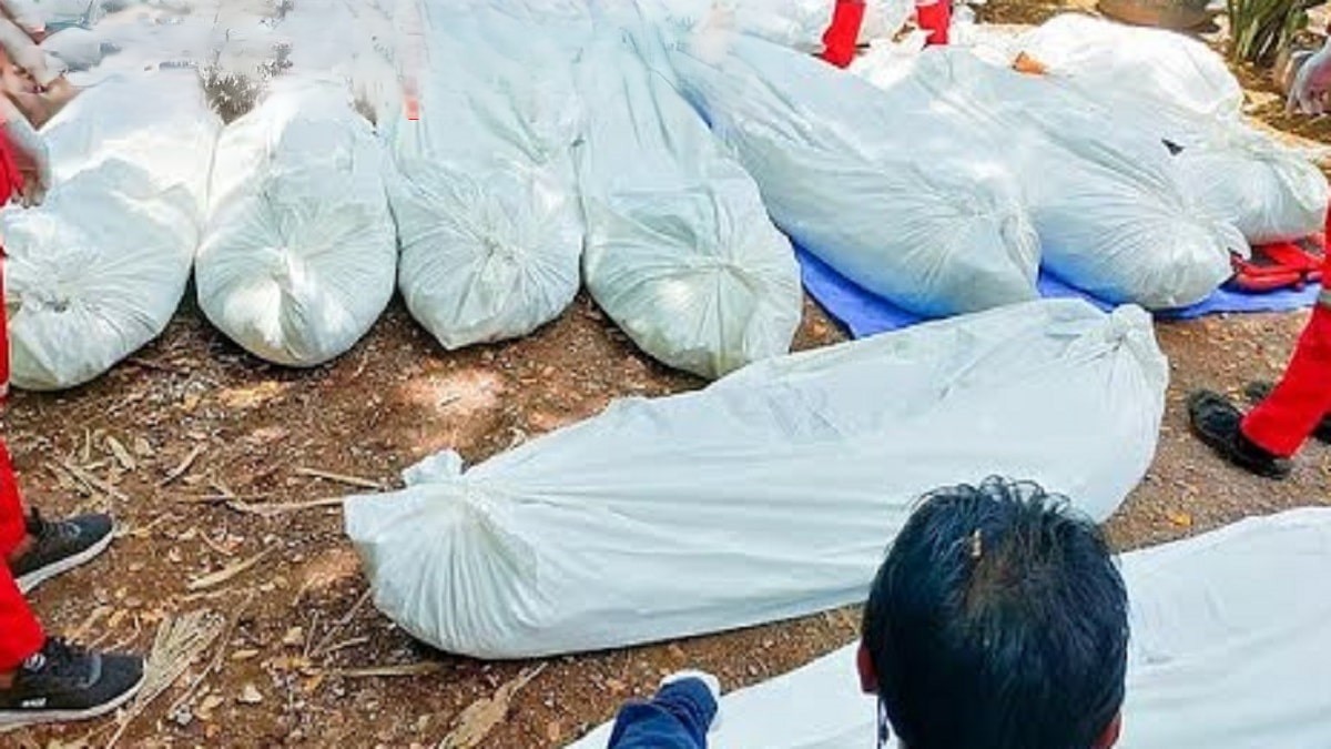 8 dead bodies wrapped in a white cloth placed on ground