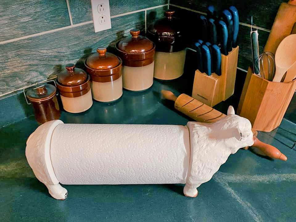 White-colored Sheep Paper Towel Holder beside knives and condiments