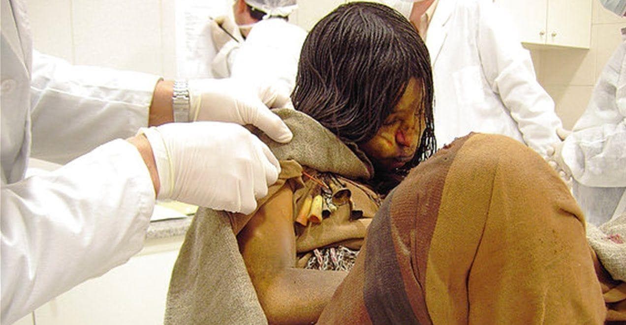 Scientists examining the incan mummified body of a child