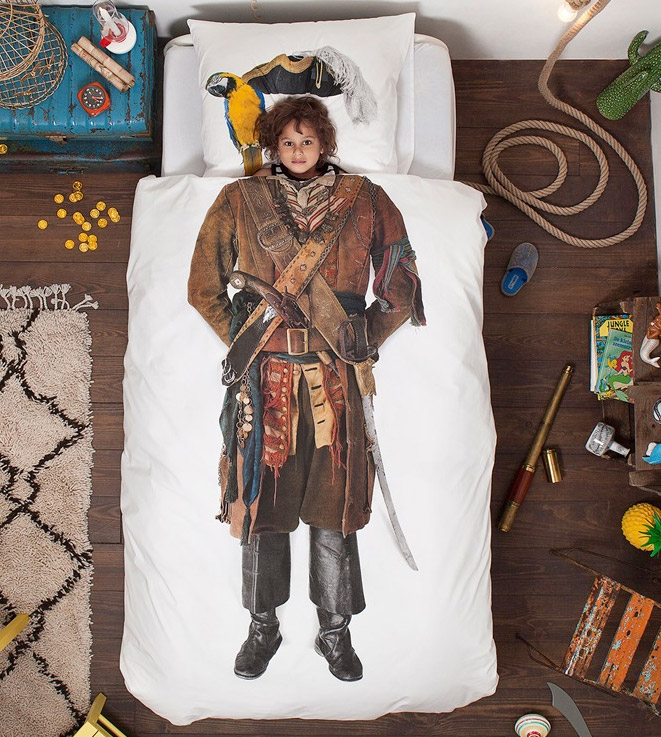 A white bed with a pirate printed on its bedsheet
