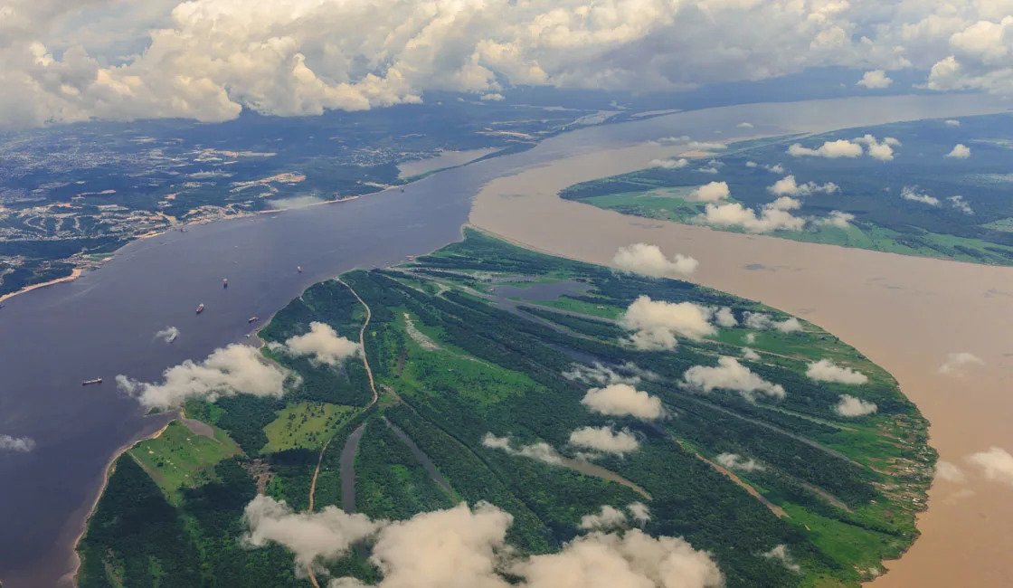 An aerial view of brown-colored amazon river meeting with the blue colored tapajos river