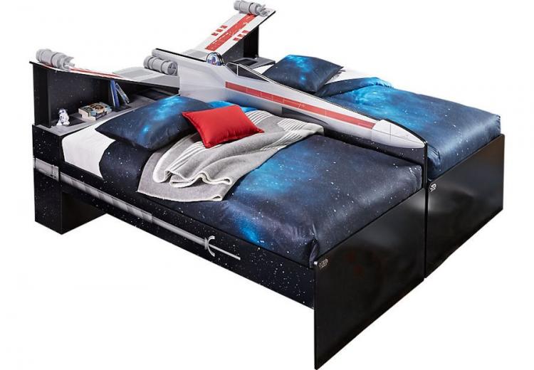 Black and blue colored bed with a grey colored rocket plane on it