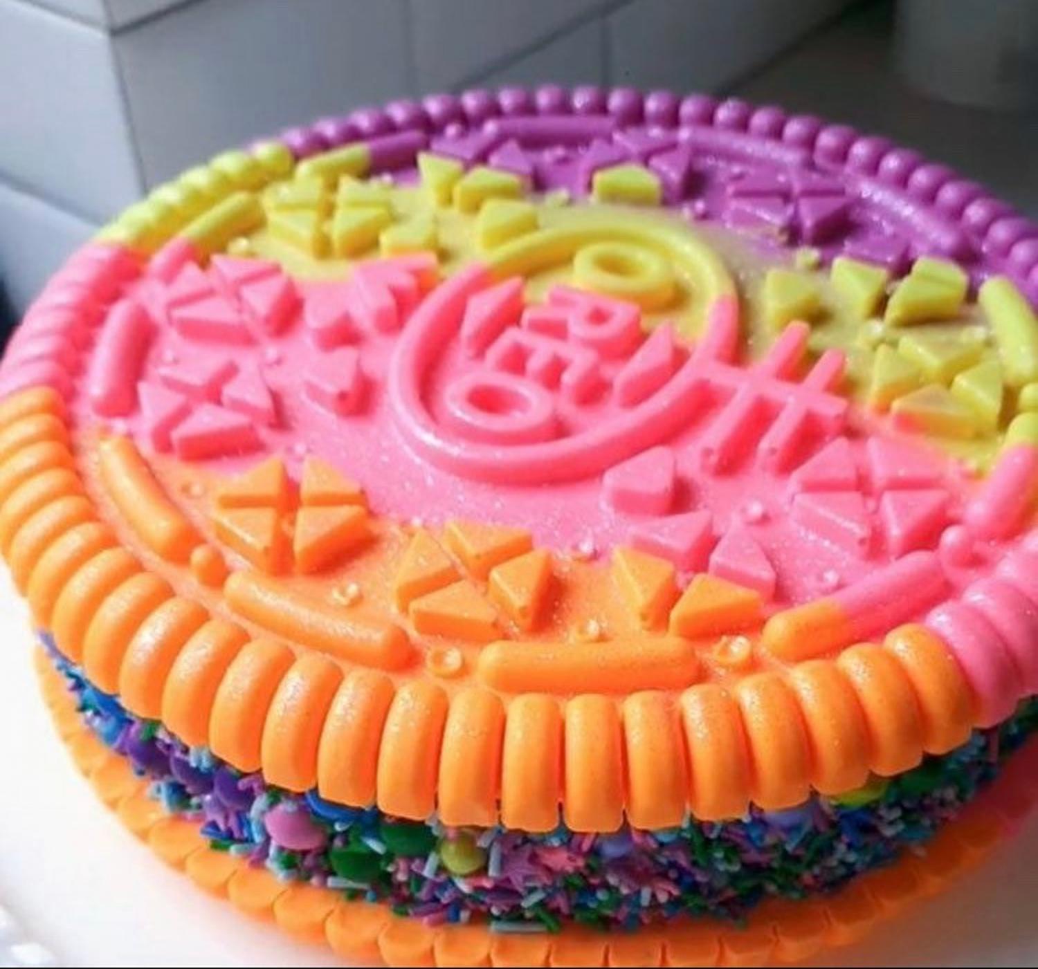 Pink, orange, yellow, and purple colored giant oreo mold cake