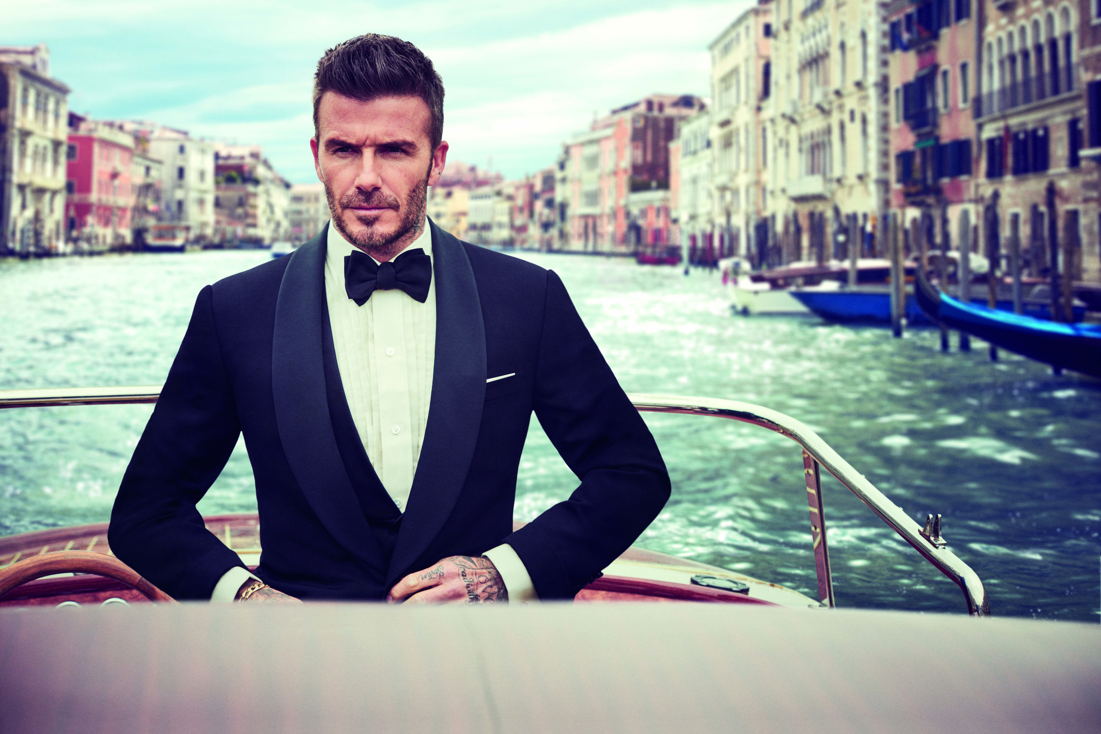 David Beckham Facebook Cover Photo as he looks to somewhere while in the boat and behind him is as river
