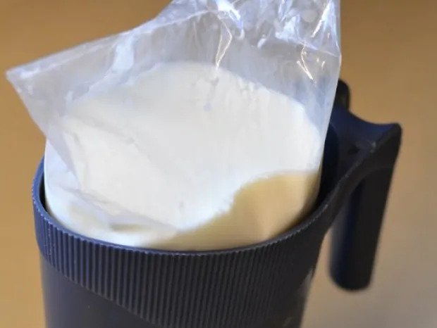 Milk bag in a black plastic jug