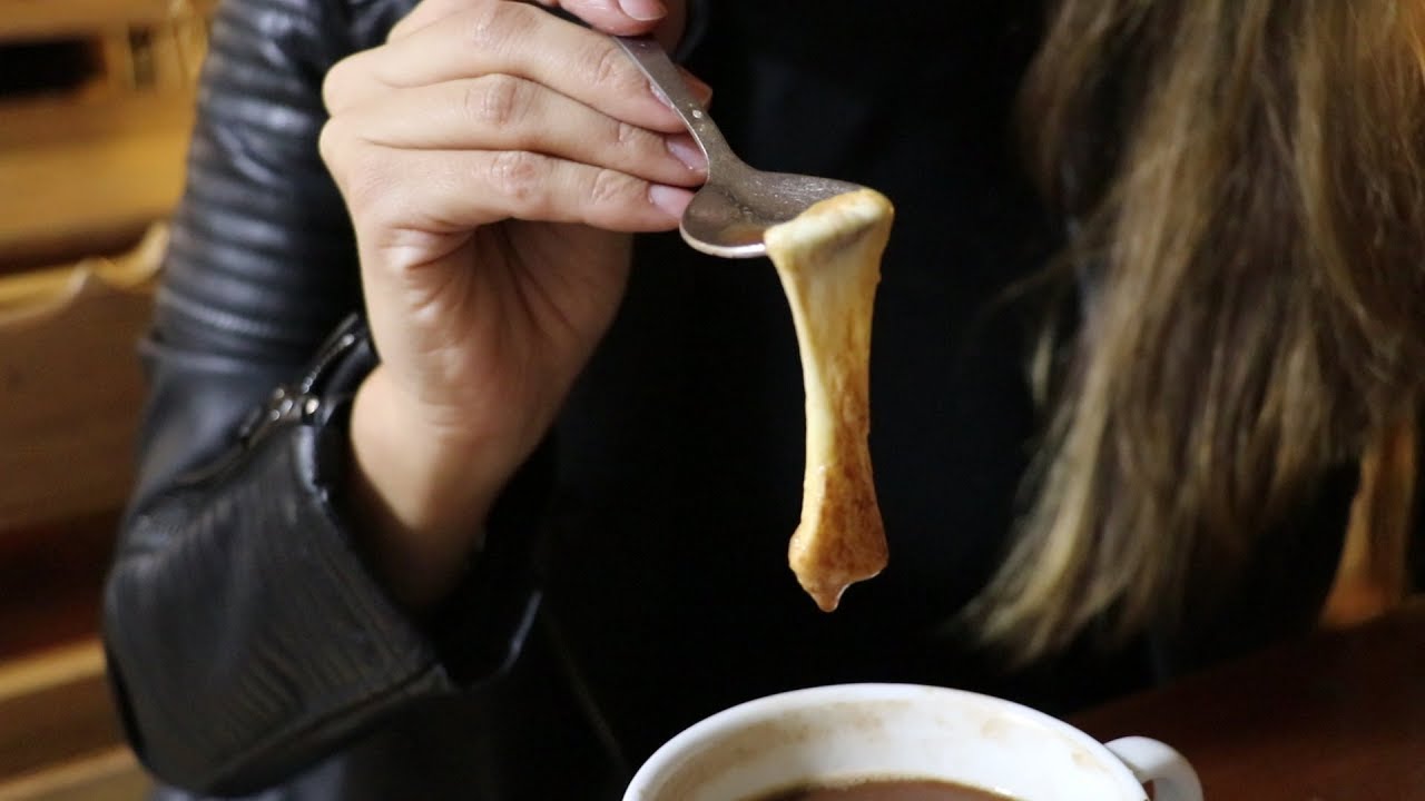 A girl having cheese with hot chocolate
