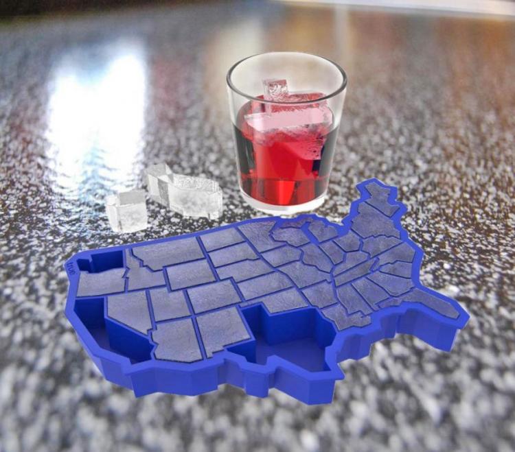 Blue colored USA map shaped ice cube tray beside a glass filled with red drink