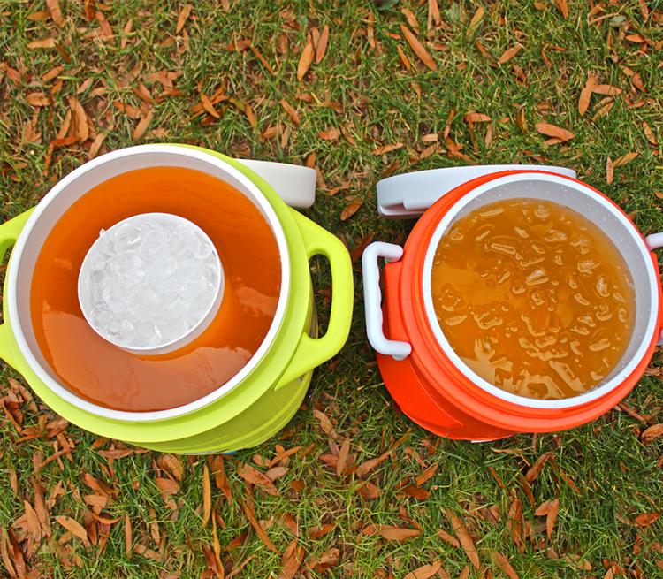 Green and orange beer cooler with beer inside them on the ground