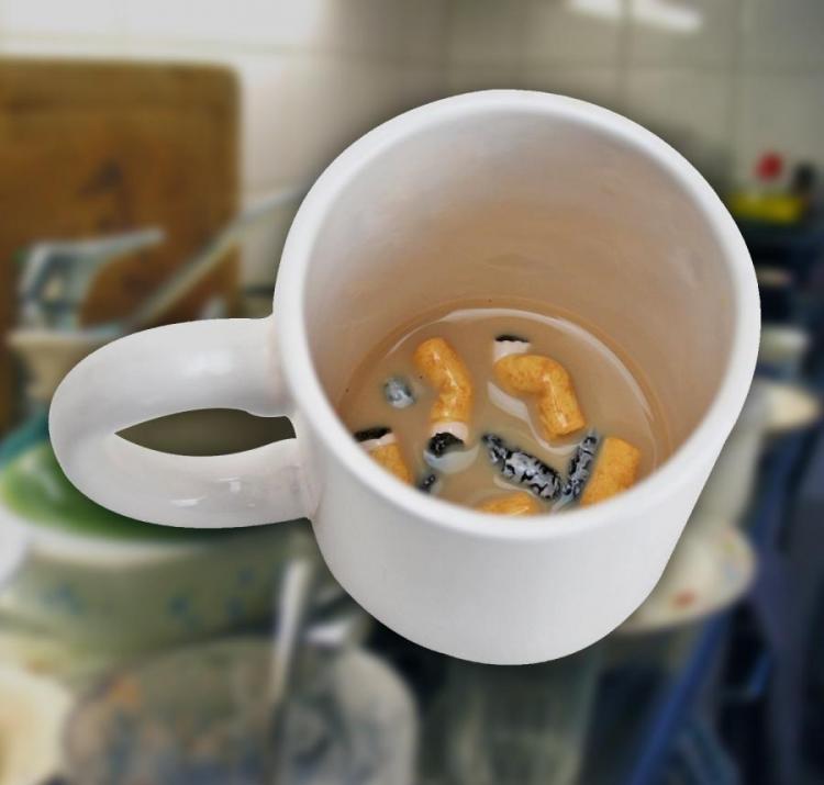 Cigarette butts in the bottom of a white mug