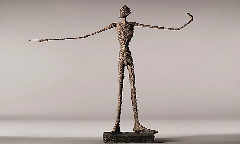 Brown-copper colored bronze pointing man statue