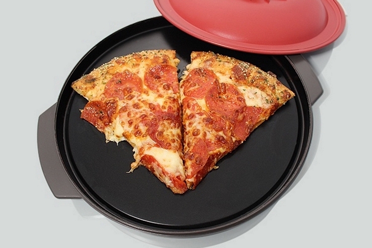 Two pizza slices being heated on a black pan
