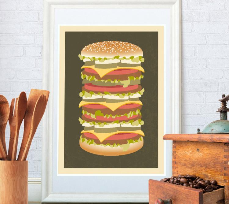 Cheeseburger poster on a white brick wall near a wooden set of spoons and a wooden drawer with coffee beans inside it