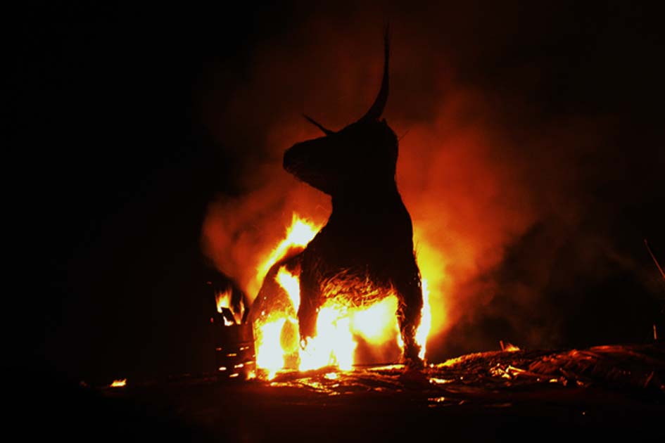 Brazen bull burning under fire
