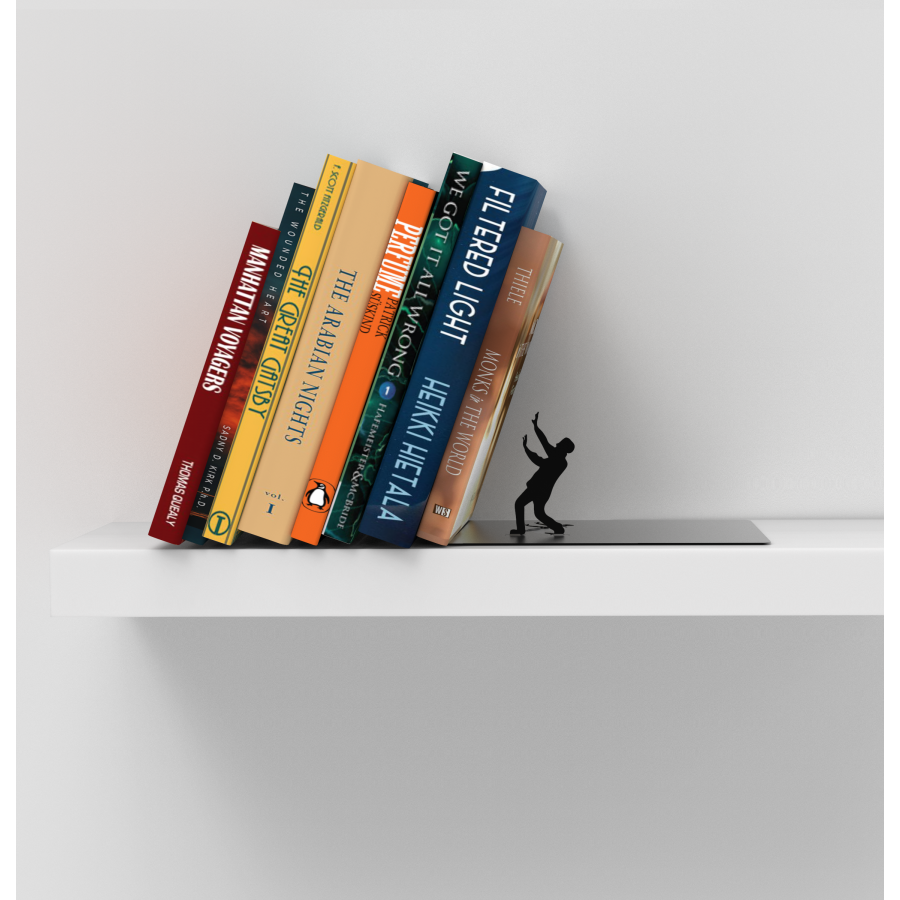 A black colored man stature leaning away from falling books bookend on a bookshelf