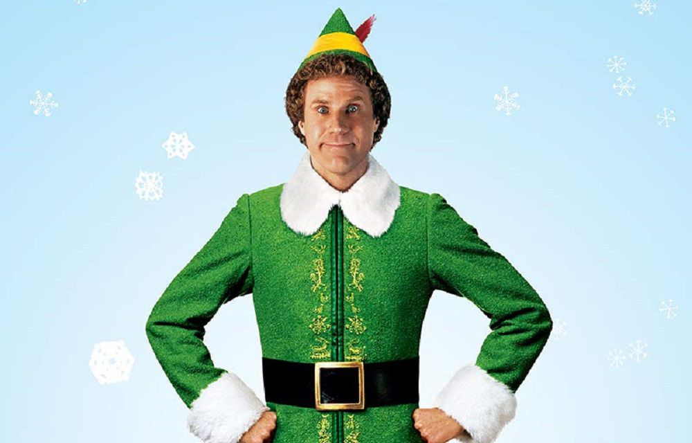 Buddy The Elf smiling while wearing his iconic costume
