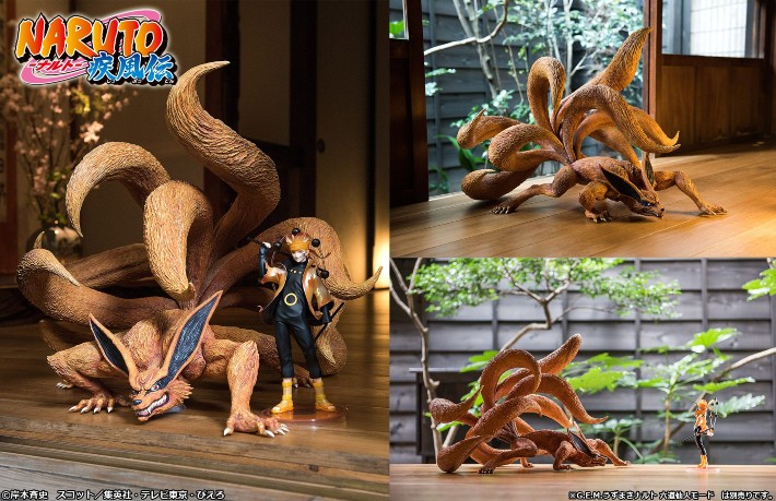 Skin-colored creepy looking nine-tailed fox next to a statue on a wooden table