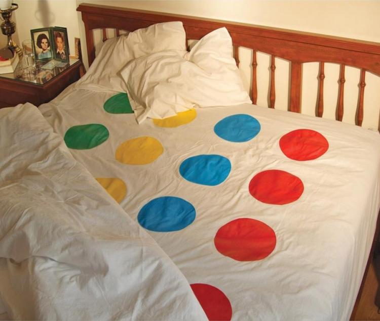 A white-colored bedsheet with red, yellow, green, and blue polka dots