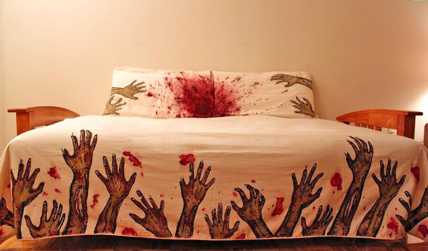 White colored bedsheet with zombie hands and blood on the edges