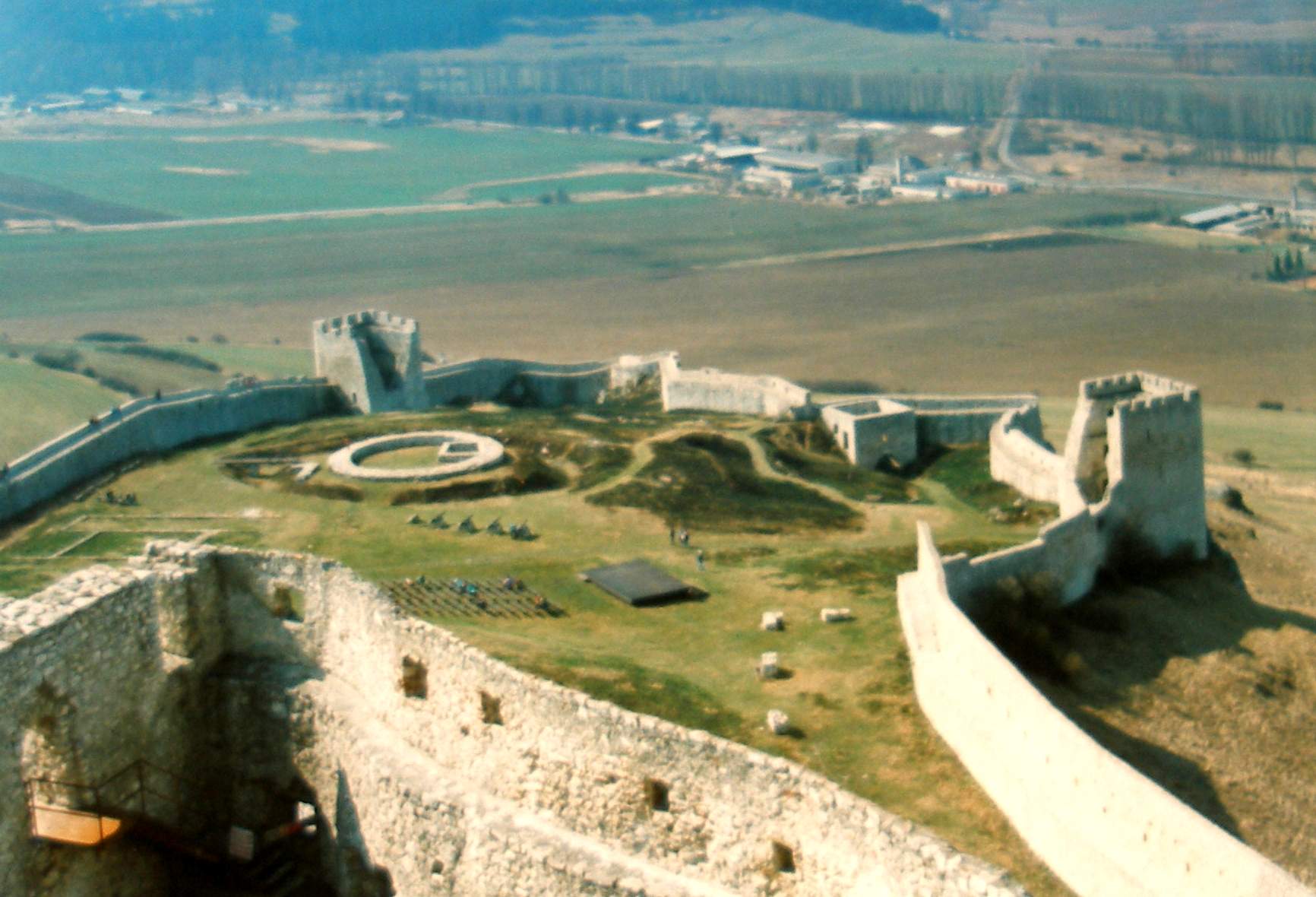 An angular drone shot of white rock gigantic Spiš Castle Slovakia