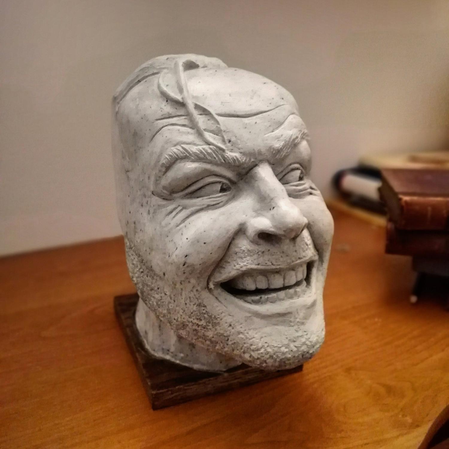 Side view of 'The Shining' Bookend on brown wooden surface