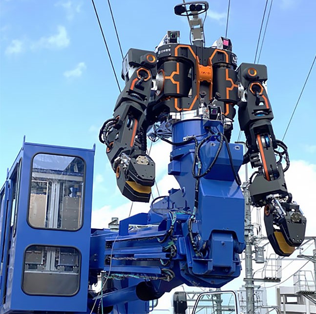 Black and orange railway robot settled on a blue machine