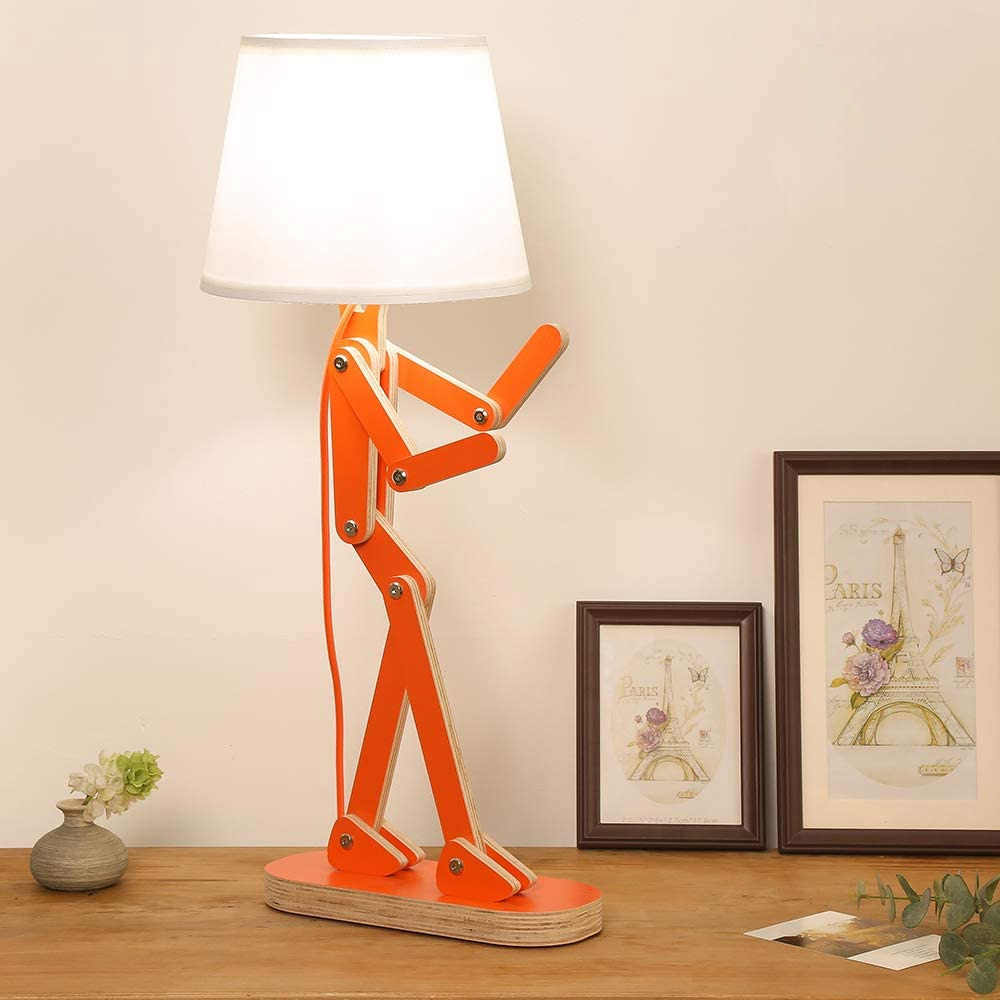 An orange-colored fighting Man Adjustable Wooden Lamp on a brown wooden table