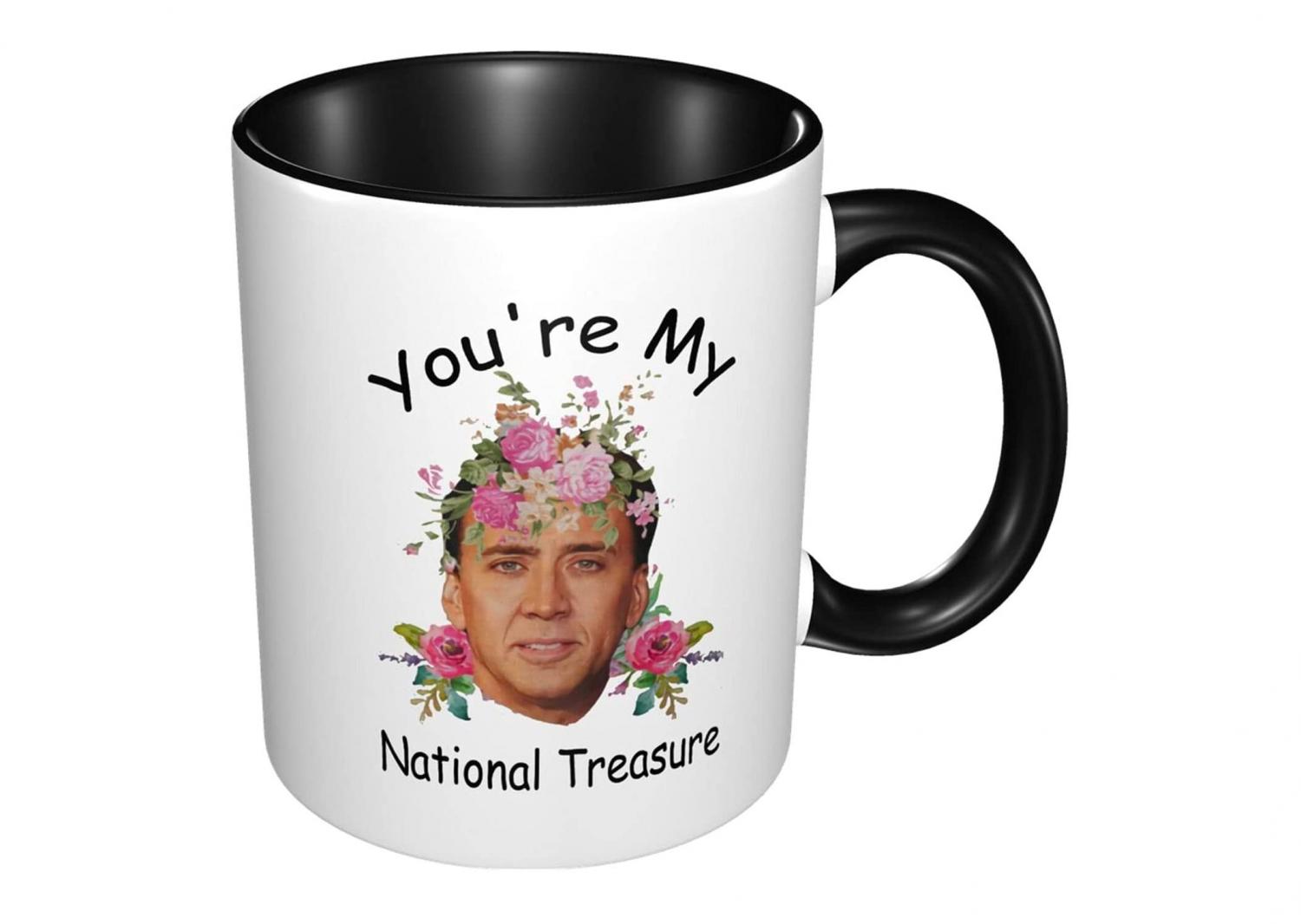 White-colored national treasure nicolas cage mug with black handle