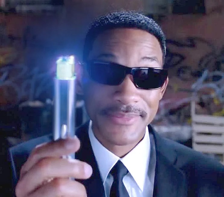 Will smith in shades and black coat holding a memory wiper from the movie Men in Black