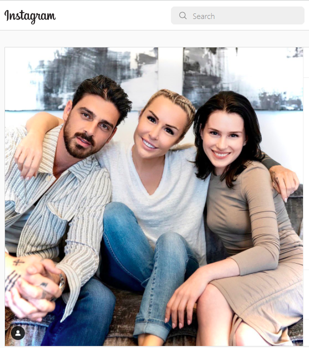 Author Blanka Lipinska (middle) with Michele Morrone (left) and Anna-Maria Sieklucka (right) sitting on a sofa