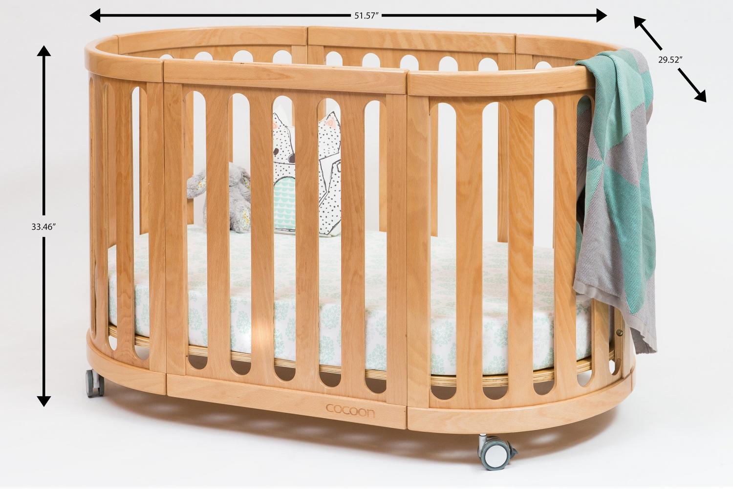 Brown wooden 4-in-1 Convertible Crib, Bassinet, And Toddler Bed with its measurement