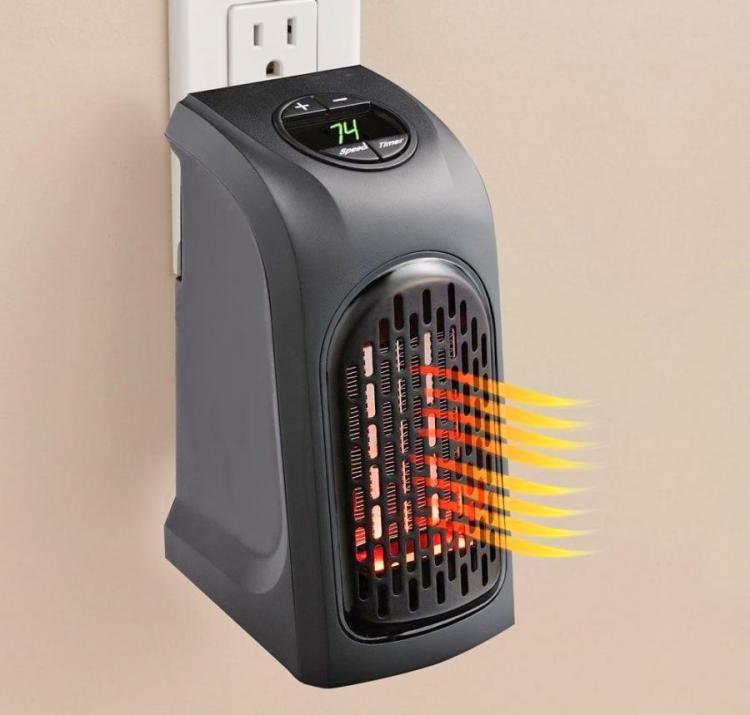 A black mini heater mounted on a white switchboard