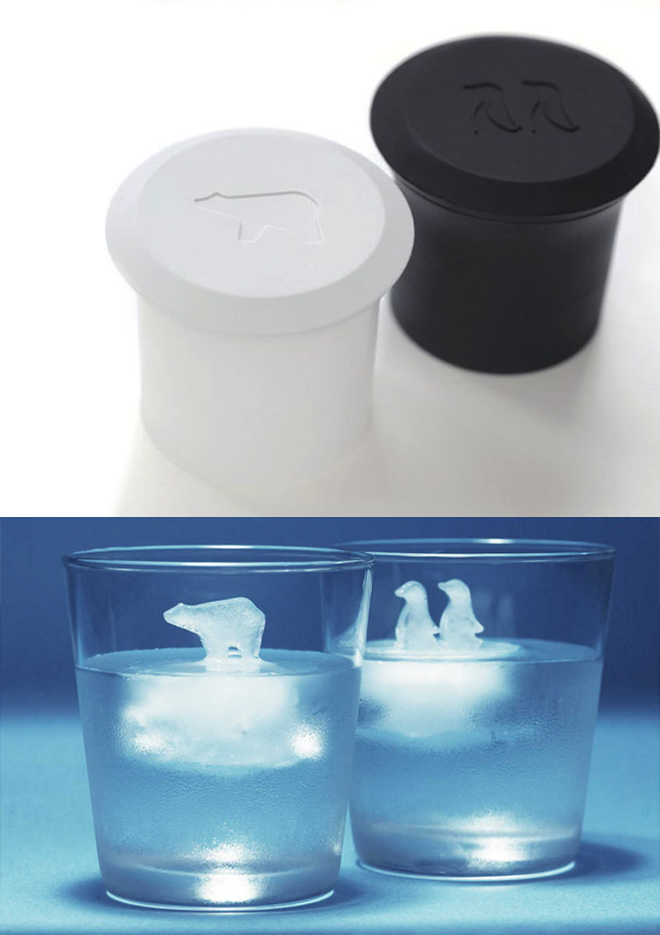 Black penguin ice cube mold and white polar bear ice cube mold, two glasses filled with water with polar bear and penguins ice cubes in them