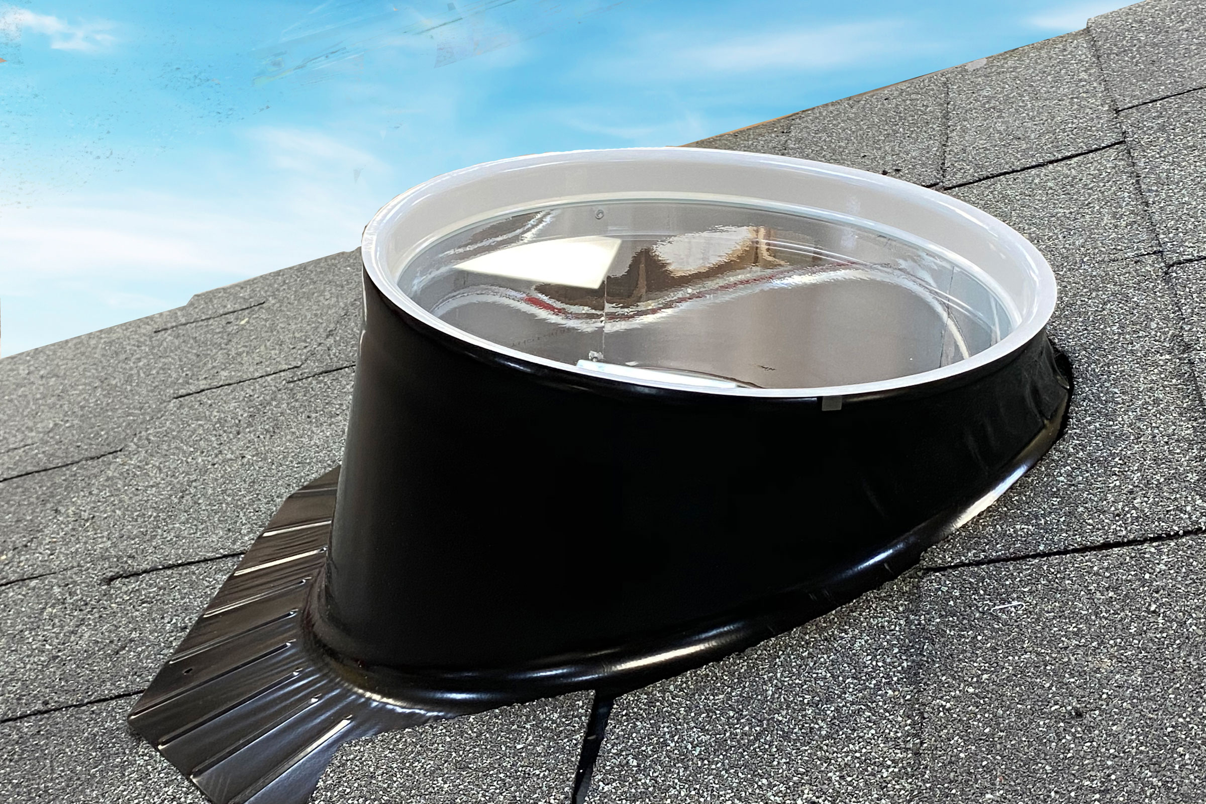 An outside view of black solatube on a grey ceramic roof
