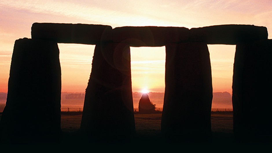 A close up shot of stonehenge during the sunrise