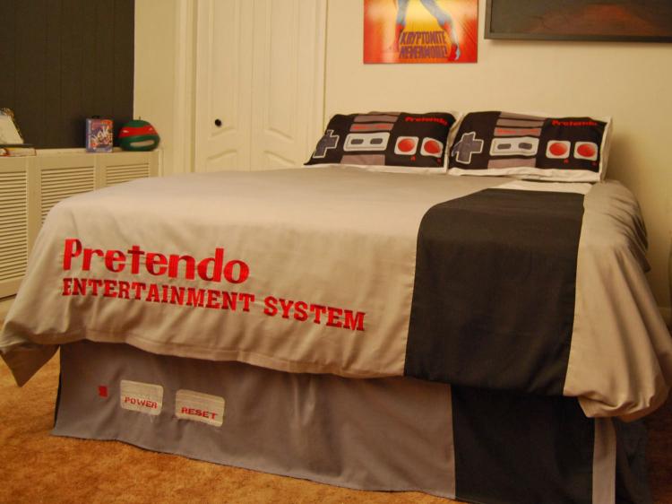 A grey and white Nintendo game-themed bed sheets with pillows